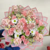 A charming mix of white daisy poms, soft pink roses, blush stock