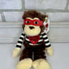 Plush monkey toy with a red mask and striped shirt