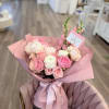 A lush, hand-tied bouquet in soft pinks, peach, cream and a touch