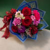 A romantic hand-tied bouquet featuring premium red roses, vibrant carnations, seasonal blooms