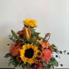 Autumn Flowers in a ceramic orange pumpkin... A very cute squirrel stands