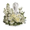 White floral arrangement with angel figurine centerpiece