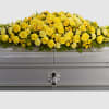 Yellow floral spray on a silver casket