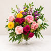 A garden style arrangement featuring garden roses, spray roses, dahlias, snapdragons, clematis