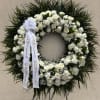 A large, formal sympathy wreath designed to offer a solemn, respectful tribute