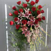 Lilies and dendrobium orchids mingle with roses and more in this magnificent