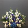 White and blue floral arrangement in a white vase