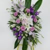 Standing floral spray with pink and white flowers on an easel