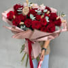Bouquet of red roses with pale eucalyptus and pink wrapping