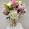 Pink and white bouquet in a gold vase