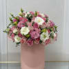 Pink and white flower arrangement in a tall blush box