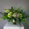 Green bouquet with hydrangeas and a succulent accent