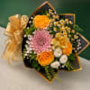 A cheerful hand-tied bouquet featuring golden roses, a soft pink chrysanthemum, delicate