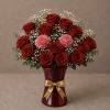 A stunning display of rich red roses, soft pink carnations, baby&rsquo;s breath