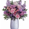 What a treat! Overflowing with pink roses and lavender blooms, this stunning