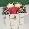 Fresh seasonal blooms arranged in our elegant purse box. Perfect for birthdays