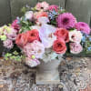 A lush, garden-style centerpiece that reads like a breath of spring-this floral