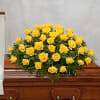 This casket spray of all yellow roses forms a golden mountain that