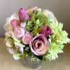 Handtied silk floral bouquet in glass vase.  Lovely combination of tulips