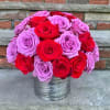 Bouquet of red and lavender roses in a silver vase