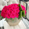 Hot pink rose bouquet in a round beige vase