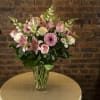 Pink and white mixed flower bouquet in a clear glass vase
