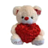 White teddy bear holding a red heart