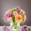 Peach and pink flower bouquet in a clear glass vase