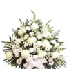 White floral standing spray with a ribbon on a pedestal