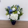 A cool, calming bouquet anchored by a dense collar of white hydrangeas