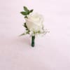 Single white rose boutonni&egrave;re with greenery and delicate filler, stem neatly wrapped