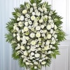 All-white standing spray arrangement with roses, football mums, ceremonies, stock, snapdragons, carnations
