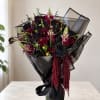 A dramatic and luxurious floral arrangement designed for lovers of dark elegance