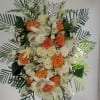 Standing floral spray with white and orange roses and lilies