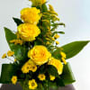 Yellow roses and small yellow daisies in a white vase