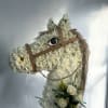Horse-shaped floral standing display with white flowers and a small bouquet