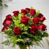 Bouquet of red roses with greenery and a gold ribbon