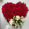 Heart-shaped red carnation arrangement with white roses and ribbon