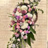 Large cascading floral wreath with pink and white blooms