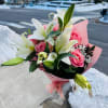 Pink rose and white lily bouquet wrapped in pink paper