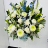 Large white and blue floral standing arrangement on a white stand