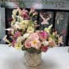 Pink and white mixed bouquet in a floral-patterned vase
