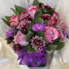 Pink and purple bouquet with roses and chrysanthemums tied with a purple ribbon