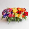 Colorful mixed rose arrangement in a rectangular container