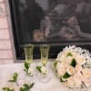 Cream rose bouquet with matching boutonnieres and champagne flutes