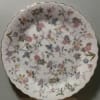 Decorative white scalloped plate with pastel floral pattern
