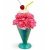 Bright pink carnations piled into a turquoise cone-shaped glass create an instant
