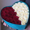 Heart-shaped box filled with red and white roses