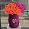 Orange rose bouquet with purple orchids in a velvet hatbox