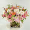 Pink and white mixed bouquet in a square glass vase